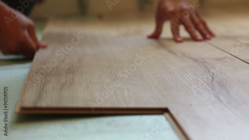worker laying laminate