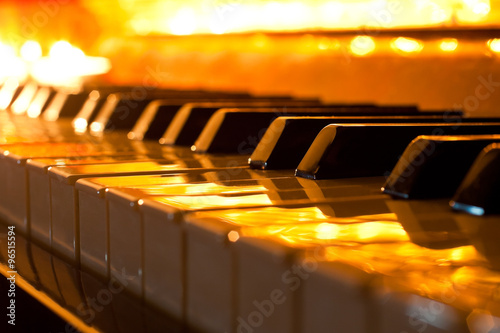 The keyboard of the piano in the golden light