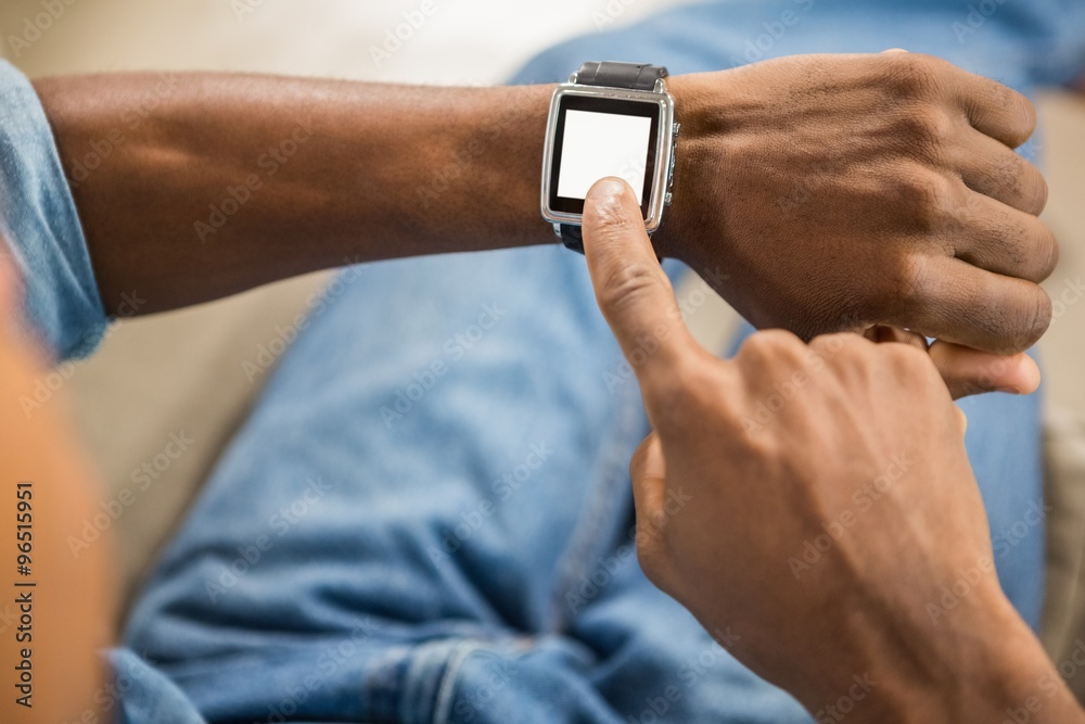 Close up view of a casual man using smart watch Close up view of a casual man using smart watch