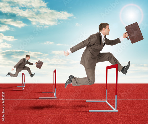 Картината върху платно Businessmen hopping over treadmill barrier