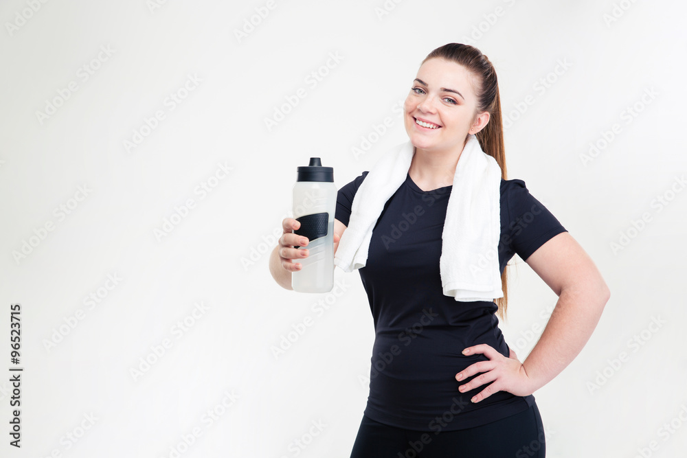 Smiling thick woman in sportswear holding shaker Smiling thick woman in sportswear holding shaker
