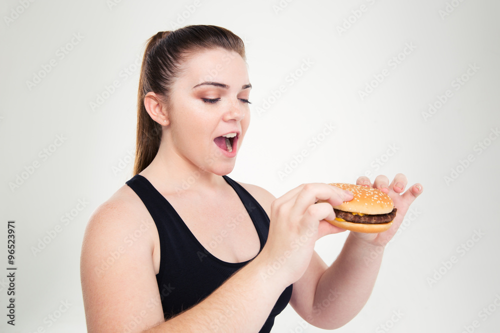 Portrait of a fat woman eating hamburger