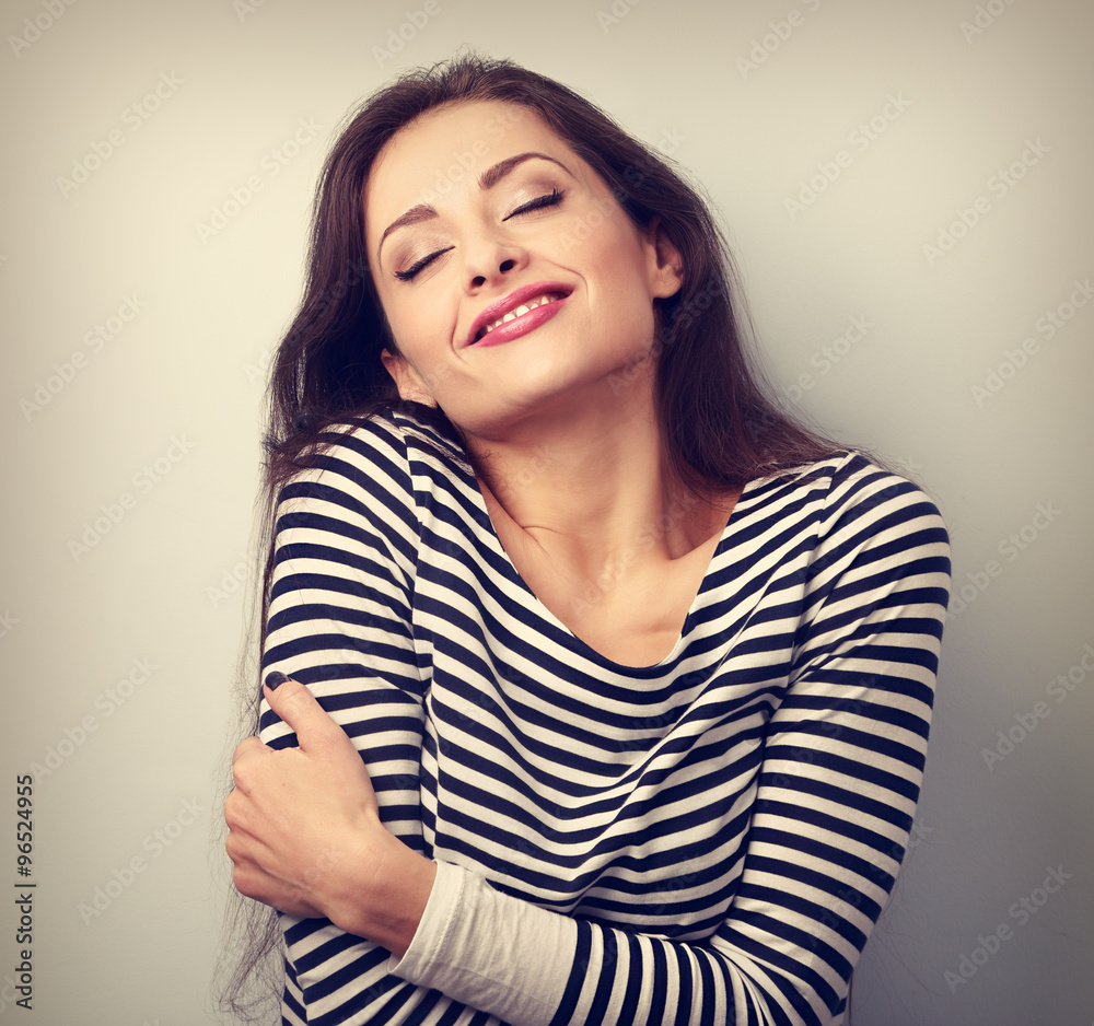 Happy young casual woman hugging herself with natural emotional Happy young casual woman hugging herself with natural emotional