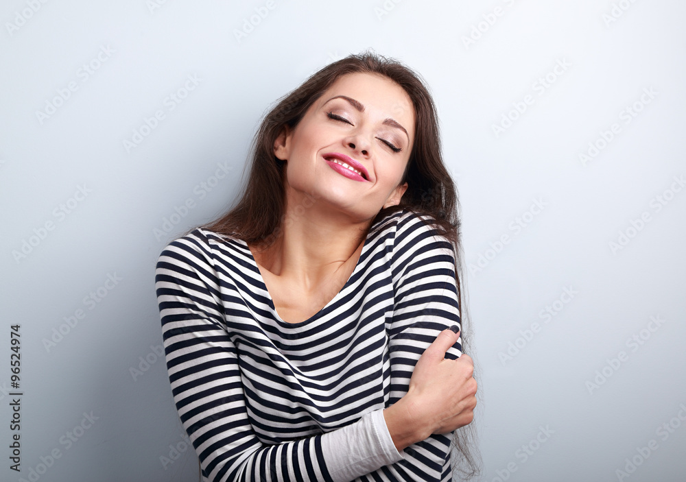 Happy young casual woman hugging herself with natural emotional Happy young casual woman hugging herself with natural emotional