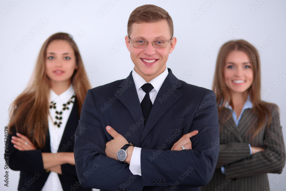 Cheerful business man with colleagues in the background, start up team Cheerful business man with colleagues in the background, start up team