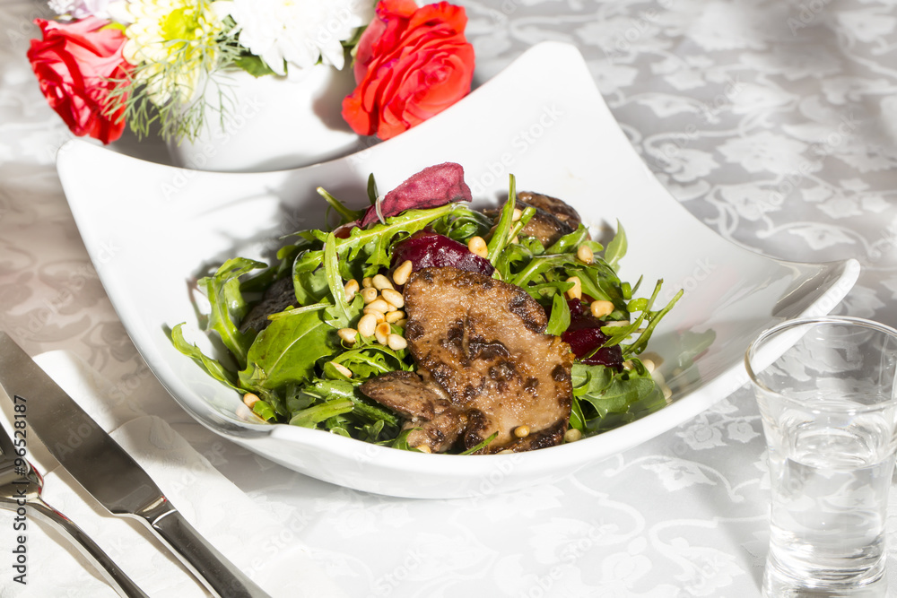 rabbit liver salad with arugula in a restaurant rabbit liver salad with arugula in a restaurant
