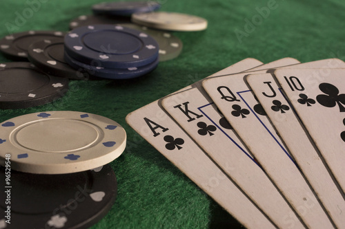 Poker cards and chips on green poker table. High resolution image.