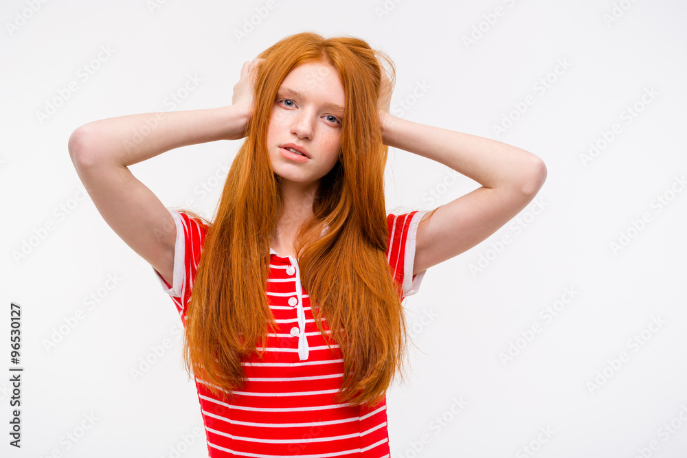 Thoughtful pretty redhead female holding head in hands Thoughtful pretty redhead female holding head in hands