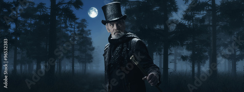 Schilderij op canvas Dickens Scrooge Man with Cane in Misty Winter Forest at Moonligh