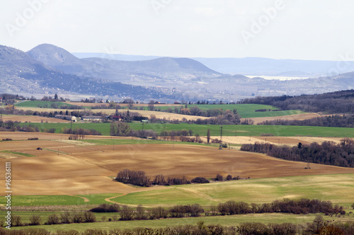Sunny landscape with hills, roads and houses