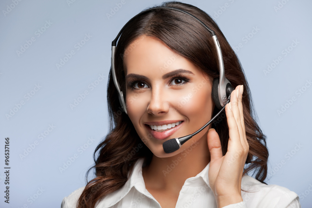 Portrait of cheerful customer support female phone operator in h Portrait of cheerful customer support female phone operator in h