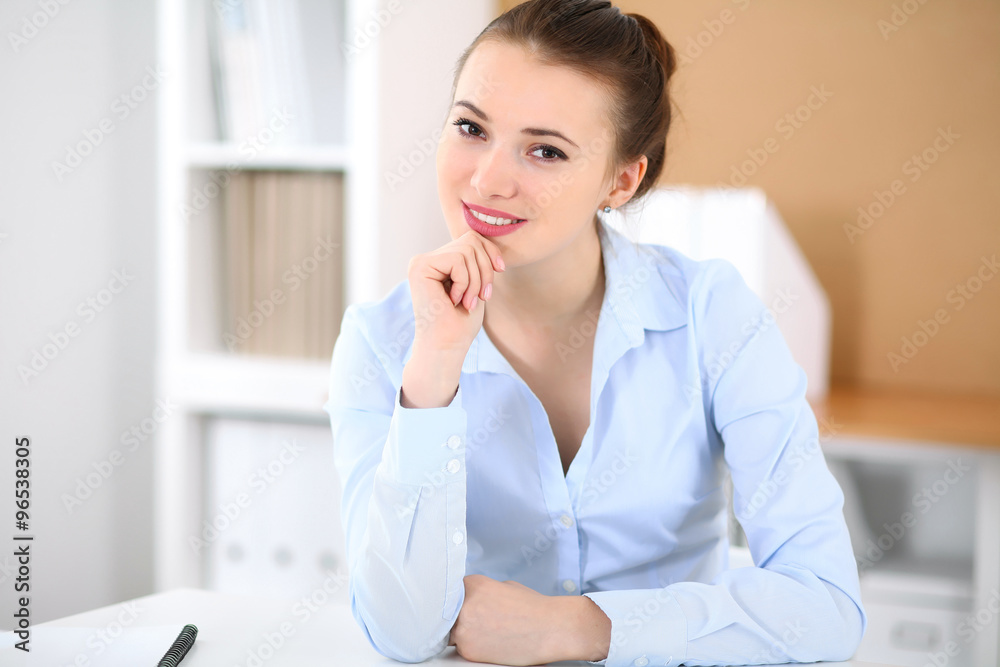 Young business woman working on laptop in office. Successful business concept. Young business woman working on laptop in office. Successful business concept.