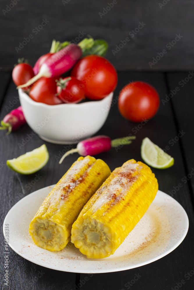 Corncob, tomato, radish, cherry tomatoes in white bowl and lime Corncob, tomato, radish, cherry tomatoes in white bowl and lime