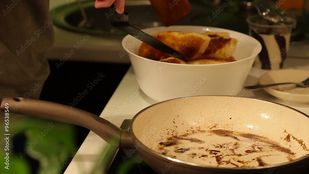 Placing homemade cakes in the pan for frying Placing homemade cakes in the pan for frying
