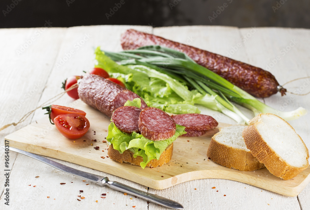 Sausage, sandwich with lettuce and slices of sausage