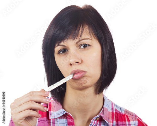Young woman with thermometer in mouth