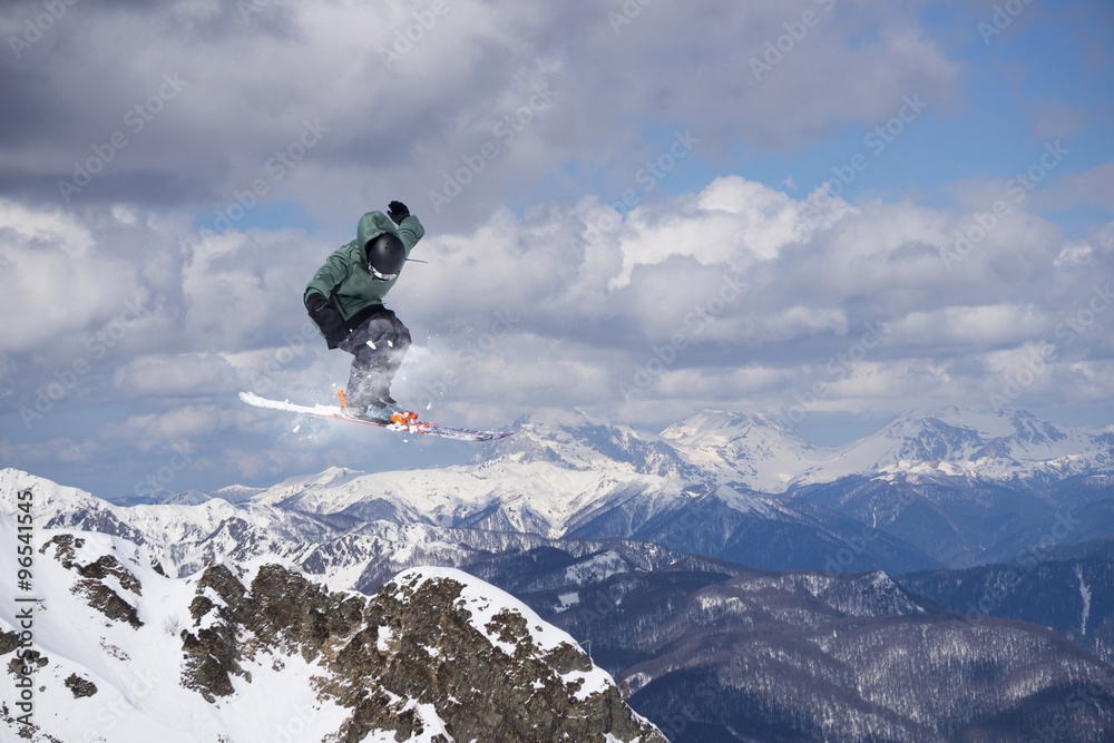 Flying skier on mountains, extreme sport