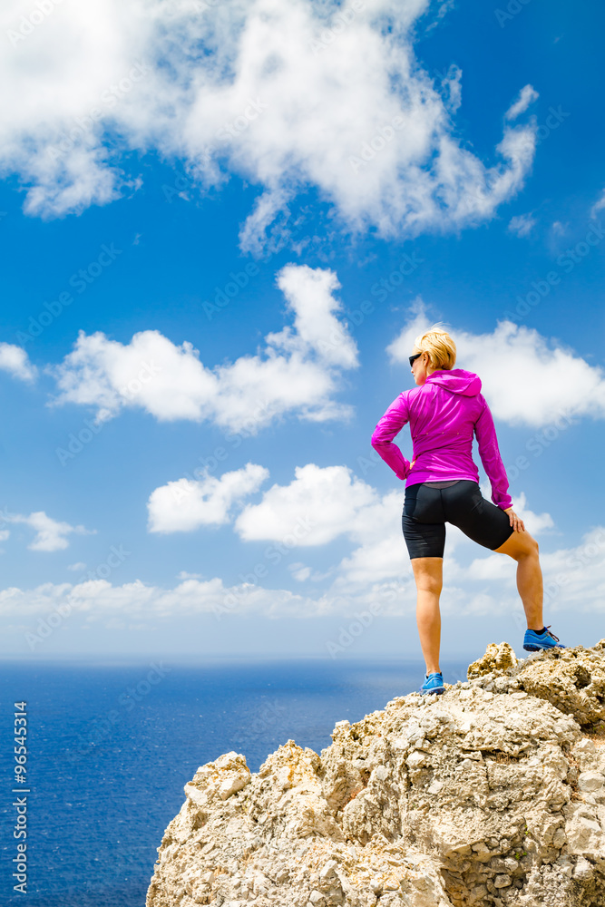 Happy trail runner looking at inspirational landscape