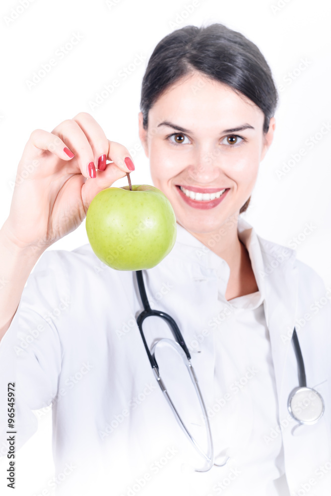 female doctor with stethoscope offering green apple - healthy lifestile female doctor with stethoscope offering green apple - healthy lifestile