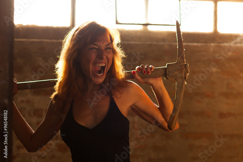 beautiful young woman posing with pickax