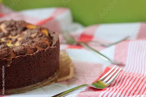 Cheesecake with chocolate shortcrust pastry and chocolate crumble arranged on a wooden board