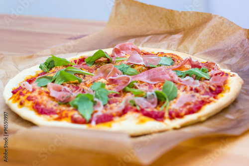 Italian style pizza with arugula and prosciutto