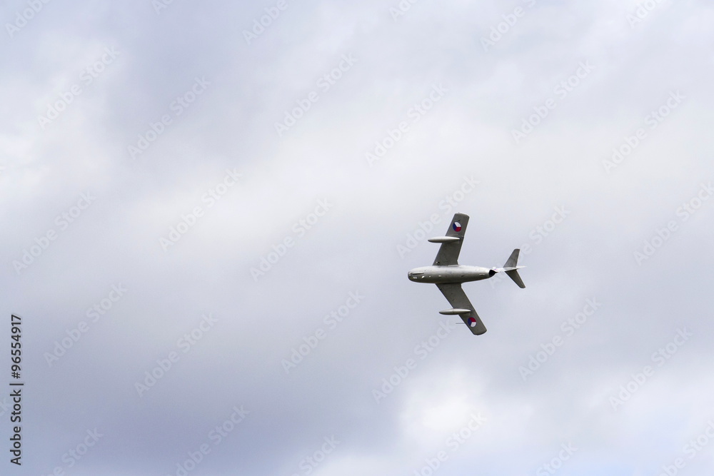 Jet fighter aircraft Mikoyan-Gurevich MiG-15 flying with dramatic clouds Jet fighter aircraft Mikoyan-Gurevich MiG-15 flying with dramatic clouds