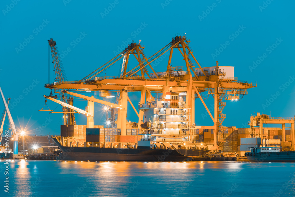 Gantry crane loading and unloading cargo container  from cargo ship at port to show global international logistics and transportation by cargo ship and cargo container, Logistic import export concept.