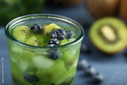 Kiwi and Blueberry cocktail on color wooden background