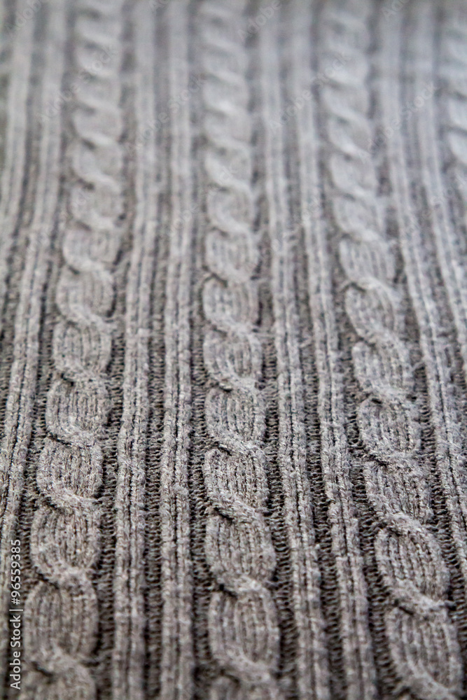 Perspective of three cables on a full frame gray cable knit sweater Perspective of three cables on a full frame gray cable knit sweater