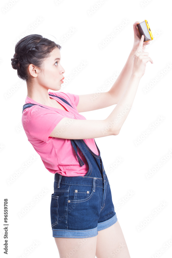 Beautiful smiling young woman taking selfies with her smart phone Beautiful smiling young woman taking selfies with her smart phone