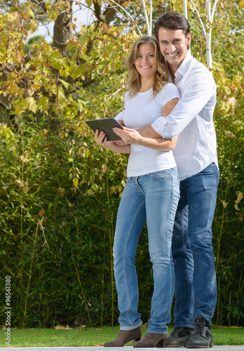 Attractive couple with tablet