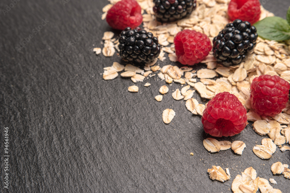 Healthy breakfast and berries on slate background, close-up Healthy breakfast and berries on slate background, close-up