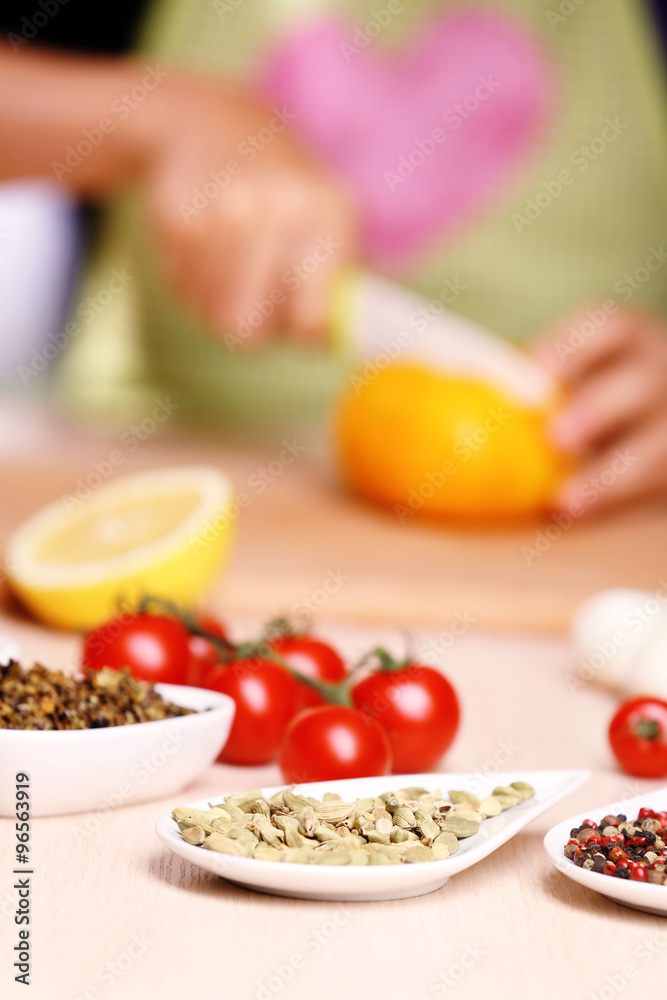 Variety of spices in ceramic containers on the kitchen table Variety of spices in ceramic containers on the kitchen table