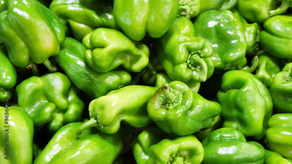 Green bell peppers with water droplets falling down in front of blurry background. Slow motion CG animation. Green bell peppers with water droplets falling down in front of blurry background. Slow motion CG animation.