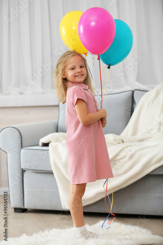 Little girl with balloons i...