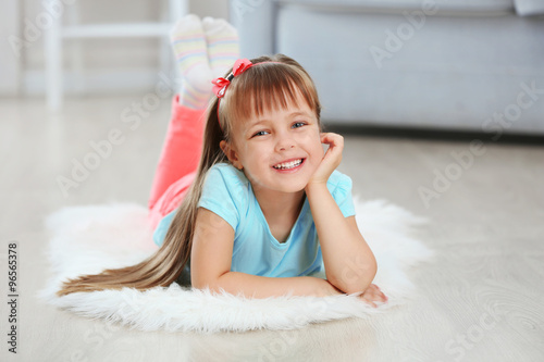 Little cute girl lying on c...