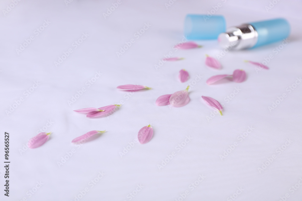 Bottle of perfume and rose petals on fabric background Bottle of perfume and rose petals on fabric background
