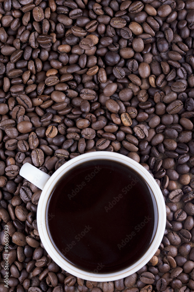 Coffee cup and coffee beans on table top view Coffee cup and coffee beans on table top view