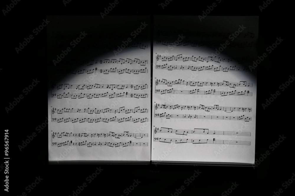 Fototapeta premium Note holder against musical instruments on wooden background, close up
