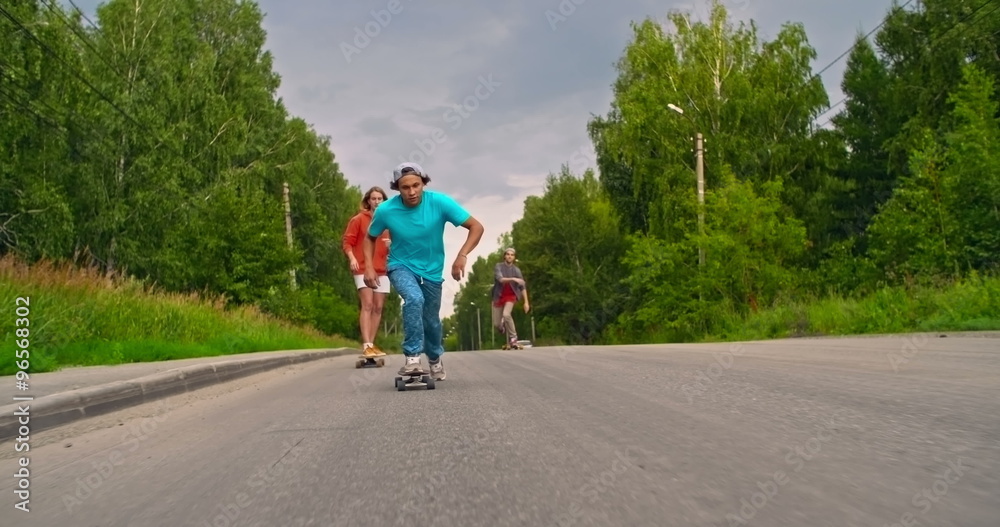 Cool teens are riding their longboards and having fun together Cool teens are riding their longboards and having fun together
