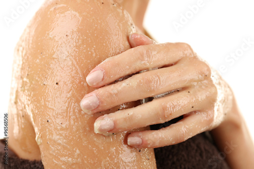 Woman using body scrub isolated on white