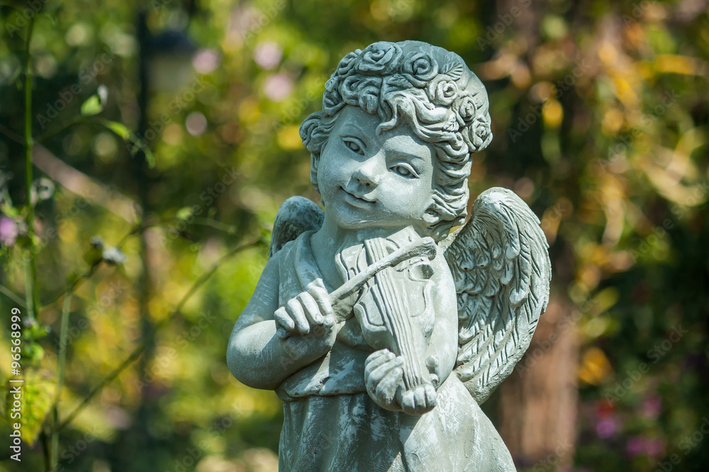 statue of an angel playing the violin