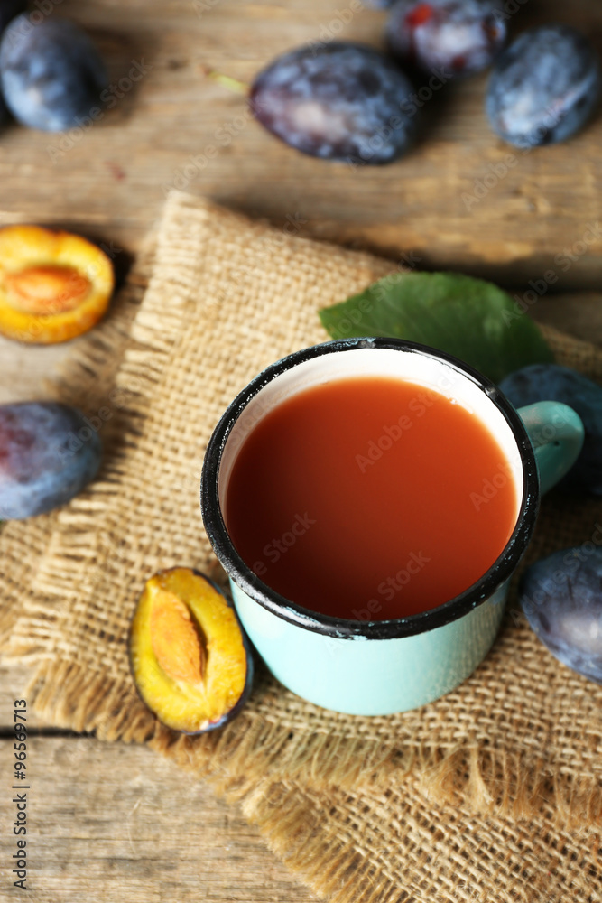 Plum Juice in a mug with fresh fruits Plum Juice in a mug with fresh fruits