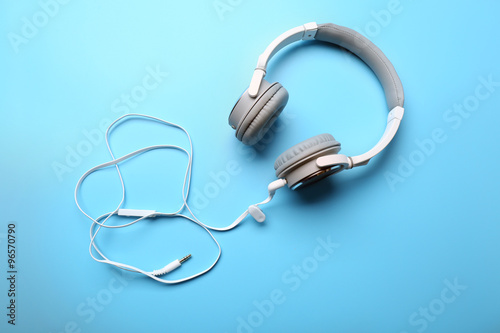 White and grey headphones on blue background