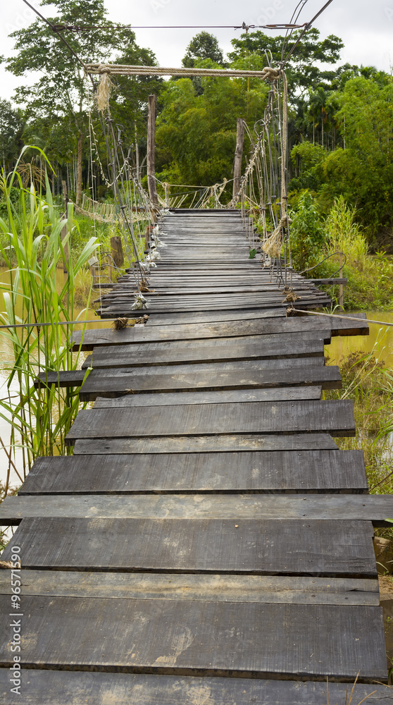 Wooden walkway across the river in south of thailand