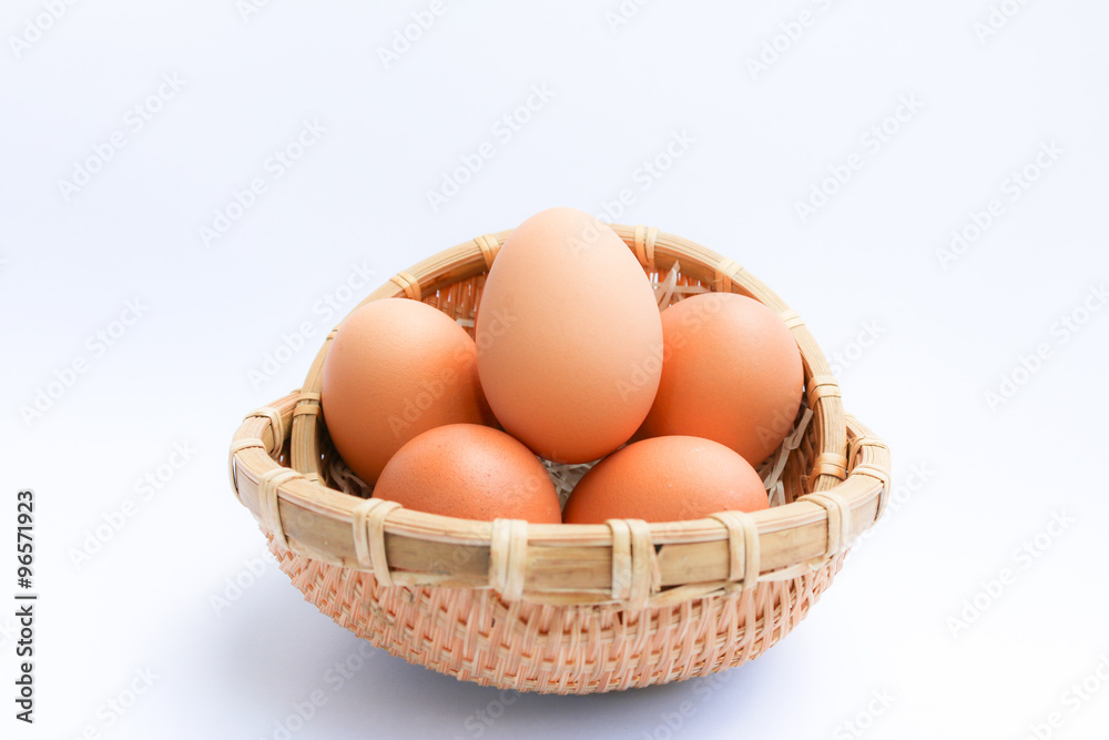 Egg in basket wicker on white background,raw eggs Egg in basket wicker on white background,raw eggs
