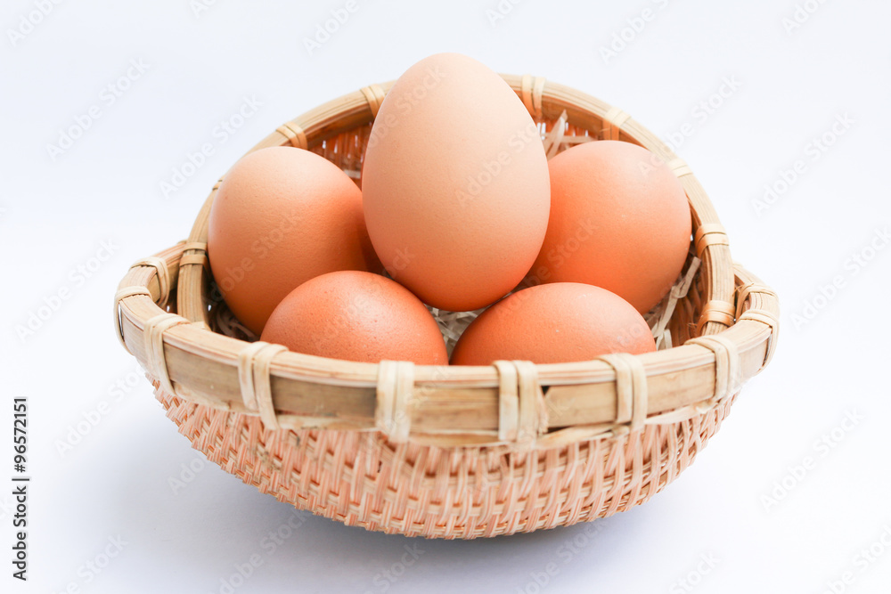  Egg in basket wicker on white background,raw eggs