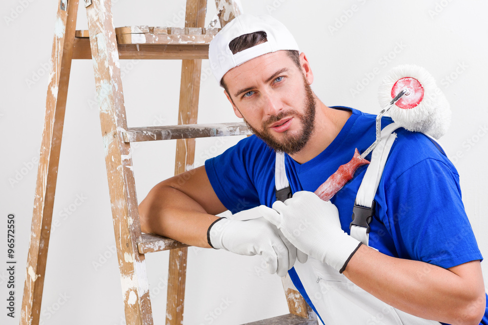 painter in white dungarees, blue t-shirt painter in white dungarees, blue t-shirt