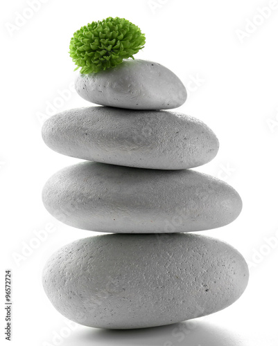 Grey spa stones and green flower  isolated on white